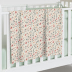 Floral patterned blanket draped over a crib