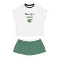 White t-shirt with 'Wake Up & Garden' text and green shorts on a white background