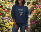Woman wearing a navy blue sweatshirt with 'Gardening is My Therapy!' text in a garden setting