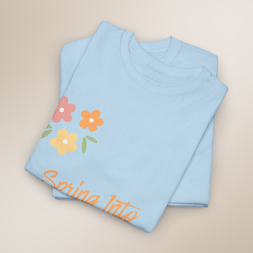 Folded light blue shirt with floral design and text on a beige background