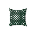 Green pillow with white polka dots on a white background