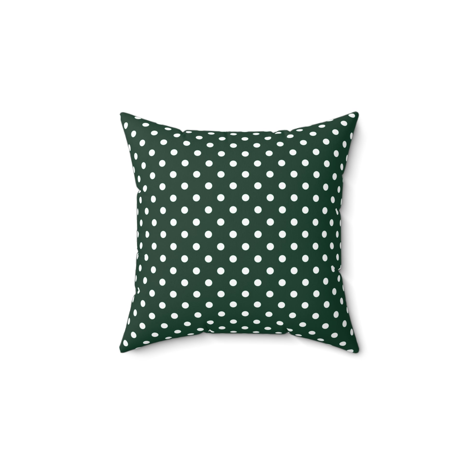 Green pillow with white polka dots on a white background