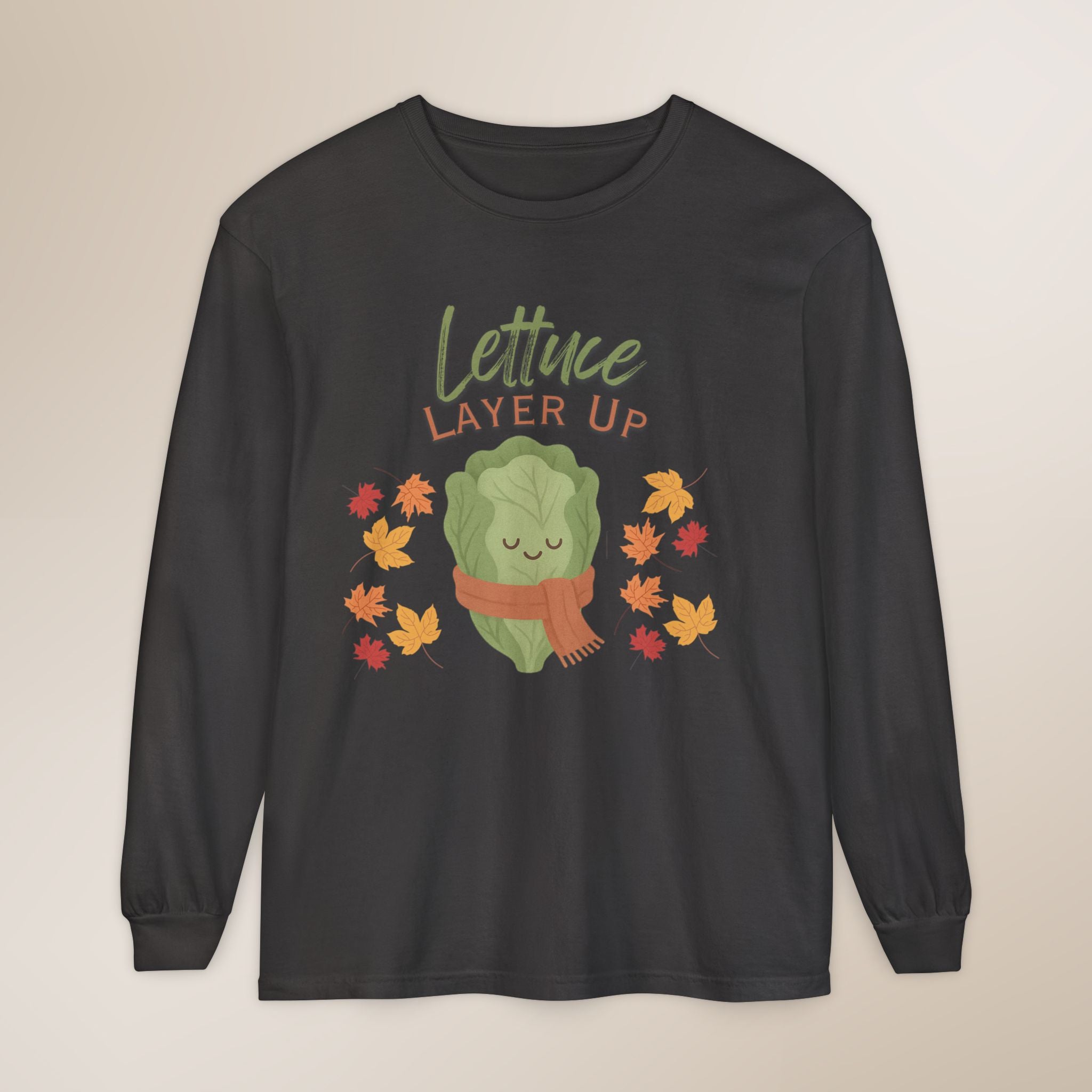 Black long-sleeve shirt with a cartoon lettuce character and 'Lettuce Layer Up' text on a beige background