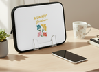 Laptop sleeve with 'Mommy Gardener' design on a desk with a phone and mug.