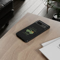 Black phone case with green design on a wooden table