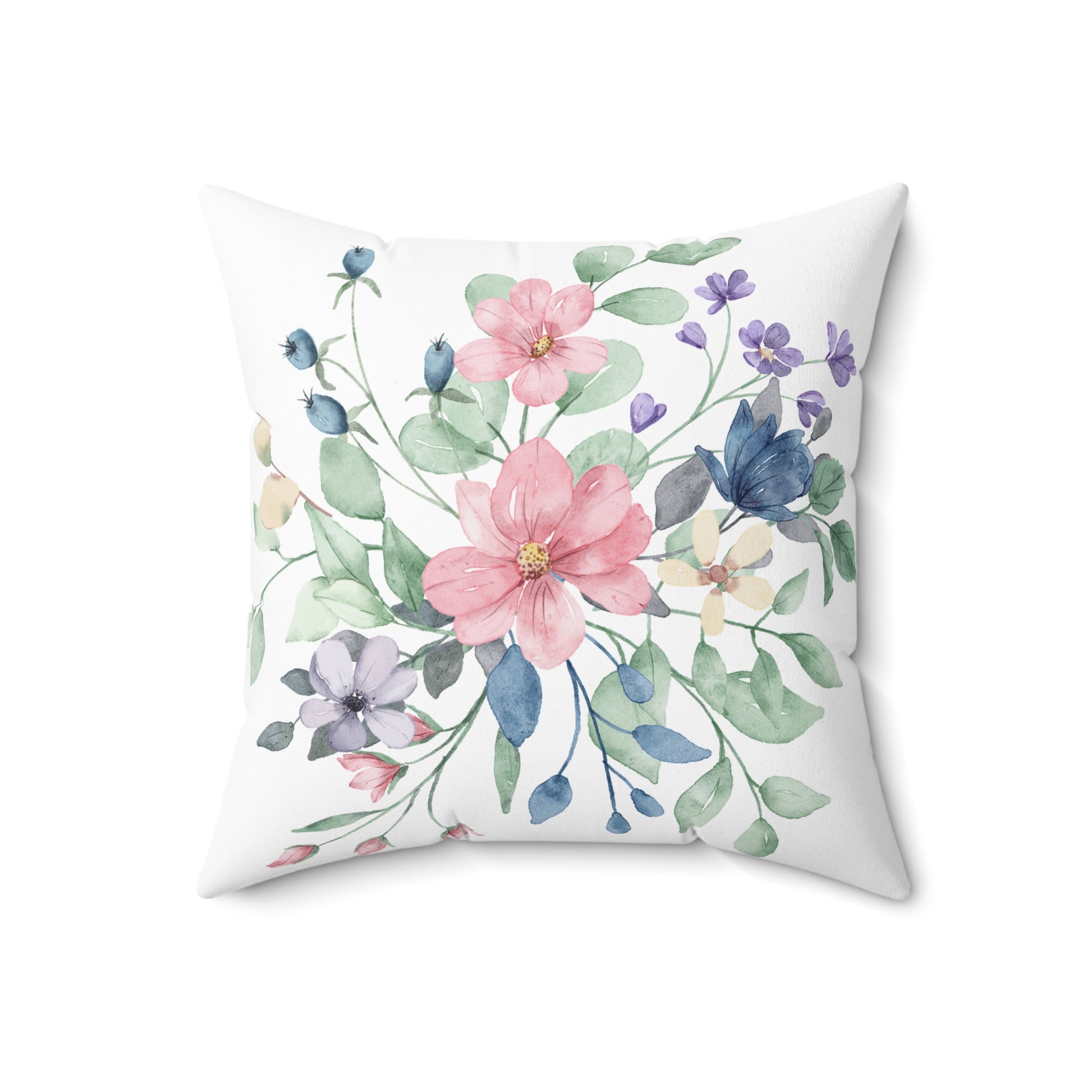 Floral pillow with pink, blue, and green flowers on a white background