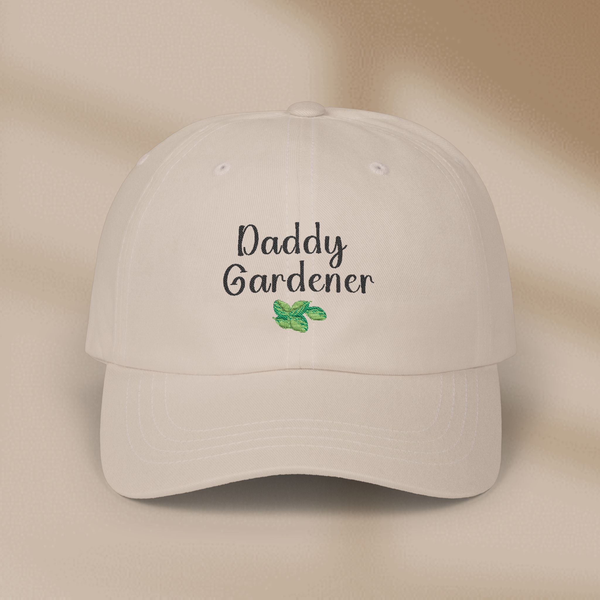 Beige cap with 'Daddy Gardener' text and leaf design on a beige background