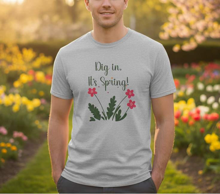 Man wearing a t-shirt with 'Dig in, It's Spring!' text and floral design in a garden setting