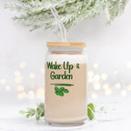 Glass jar with straw and 'Wake Up & Garden' text on a light background