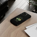 Black phone case with a green graphic on a wooden surface