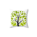 Decorative pillow with a tree design featuring green leaves on a white background