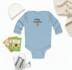 Light blue baby onesie with 'Baby Gardener' text and carrot graphic on a white background