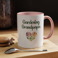 White mug with pink interior and handle, featuring 'Gardening Grandpapa' text and heart design on a wooden surface with coffee beans and a spoon.