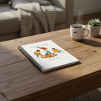 Notebook with gardening illustration on a wooden table with a cup of tea and plant in the background