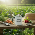 Mug labeled 'Mommy Gardener' with hot chocolate, carrots, and a hat on a garden table.