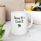 White mug with 'Grow It & Cook It' text and broccoli graphic on a wooden coaster.