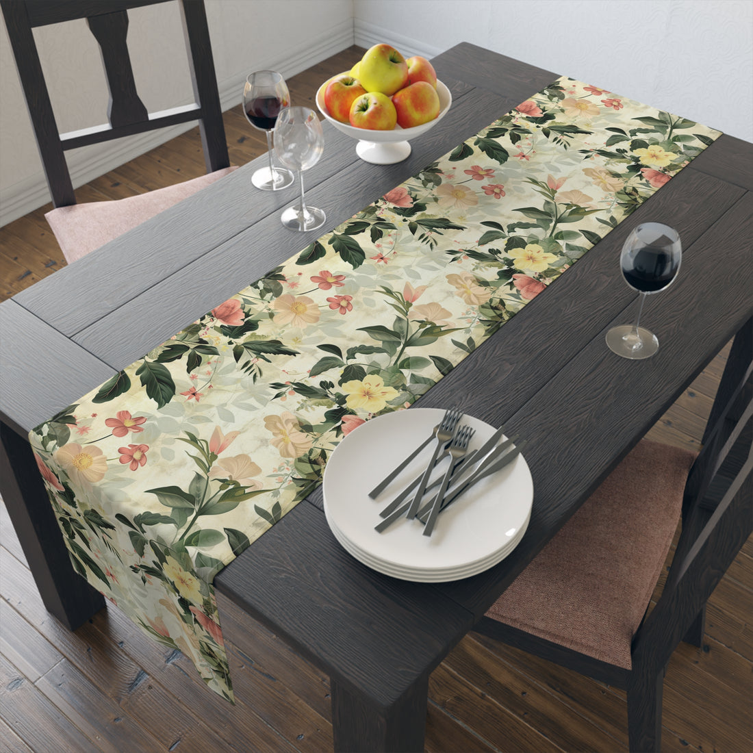 Dining table set with a floral table runner, plates, glasses, and cutlery.