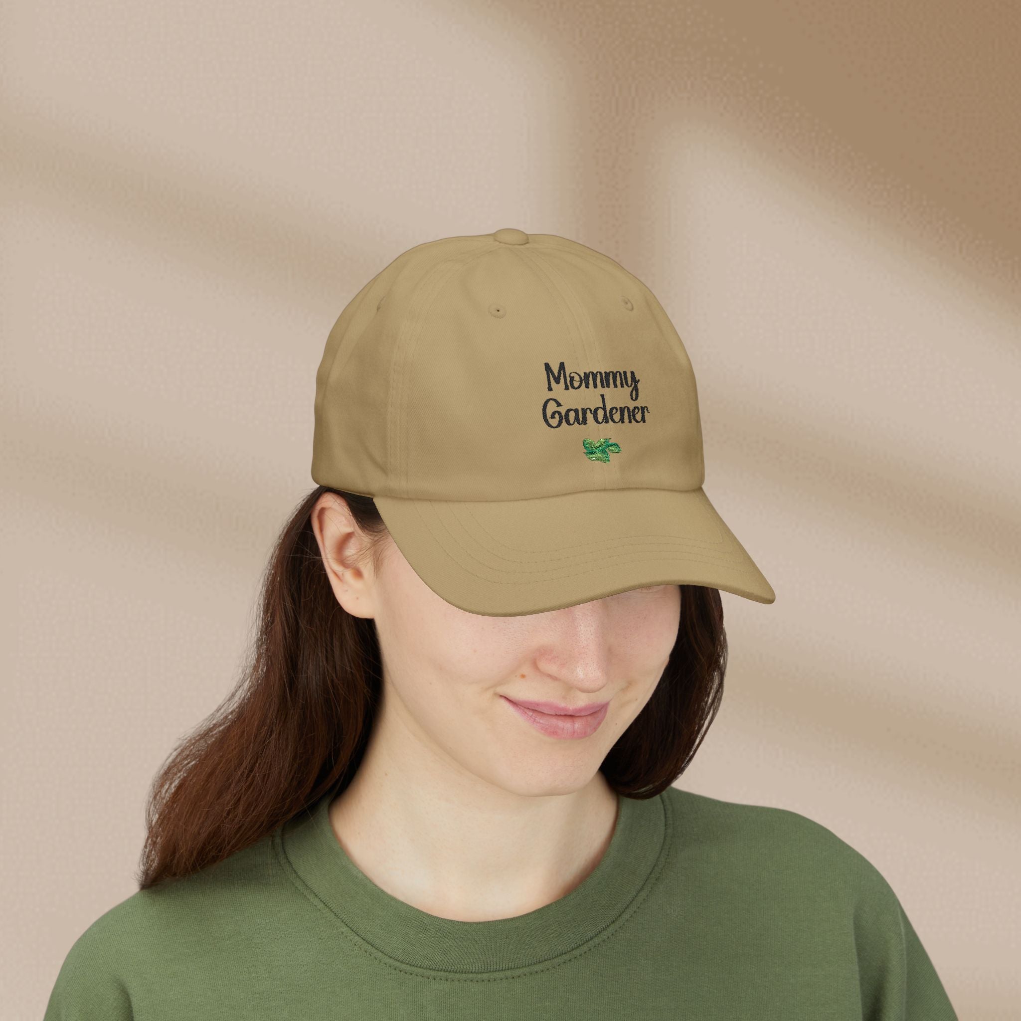 Person wearing a beige cap with 'Mommy Gardener' text on a beige background