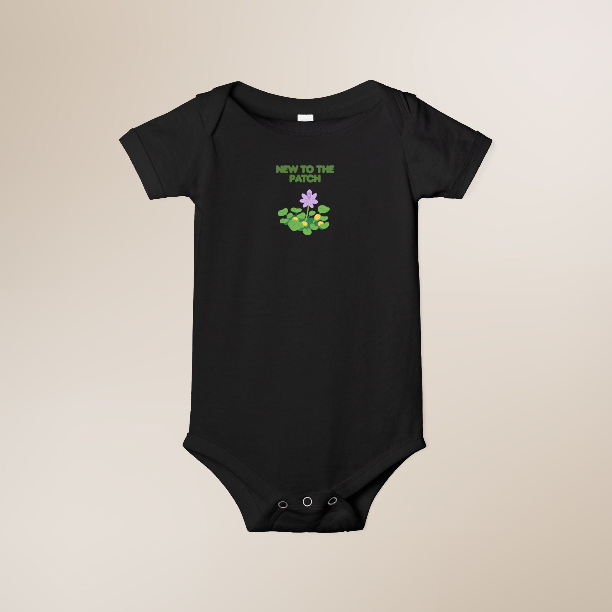 Black baby onesie with 'New to the Patch' text and graphic on a beige background