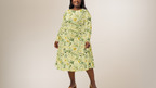 Woman wearing a floral dress on a beige background