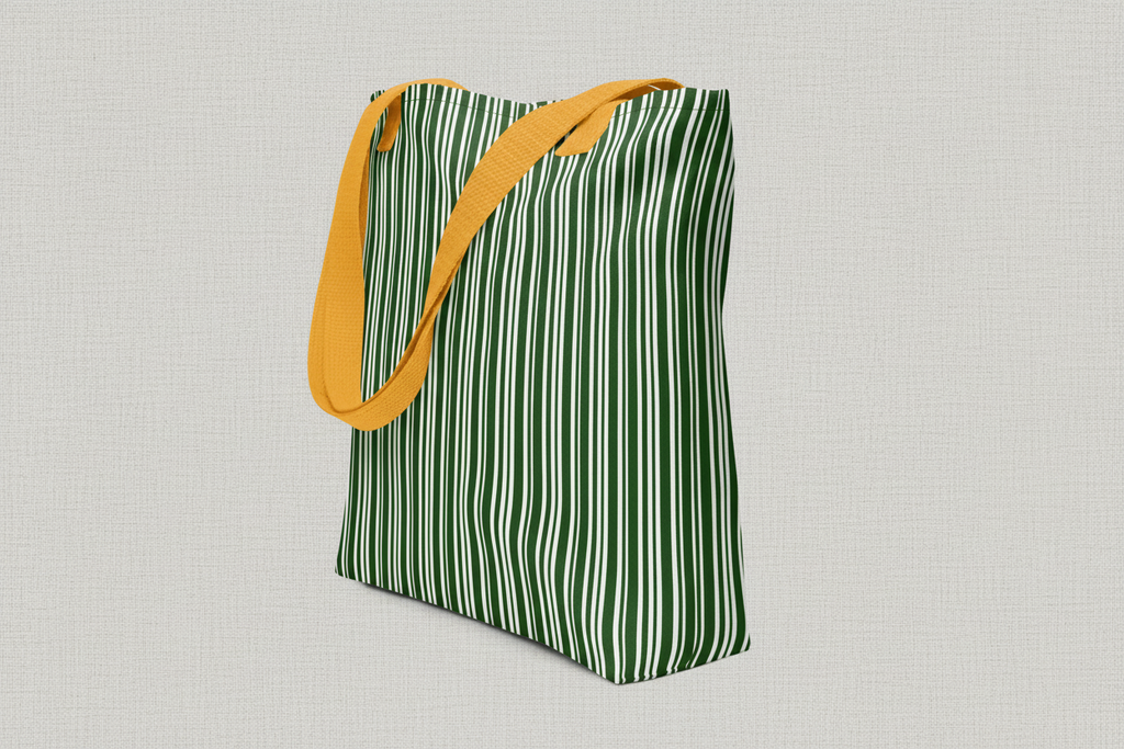 Green and white striped tote bag with yellow handle on a white background