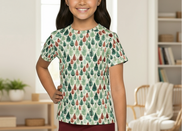Young girl wearing a patterned shirt in a home setting