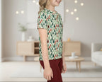 Young girl wearing a patterned shirt in a home setting with soft lighting
