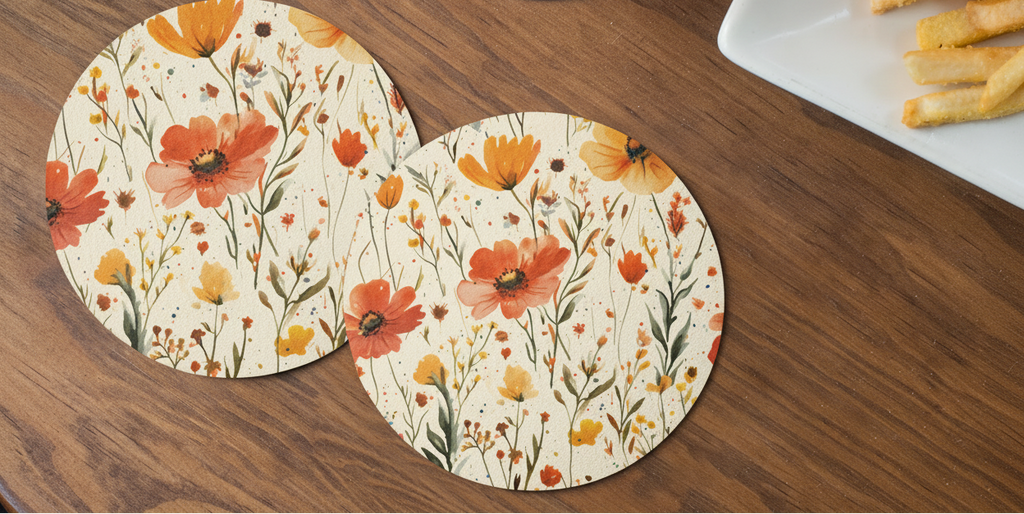 Floral coasters on a wooden table with a cup of tea and fries.