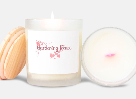 Candle with 'Gardening Peace' text and heart designs on a white background
