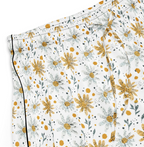 Floral patterned shorts with yellow flowers on a white background