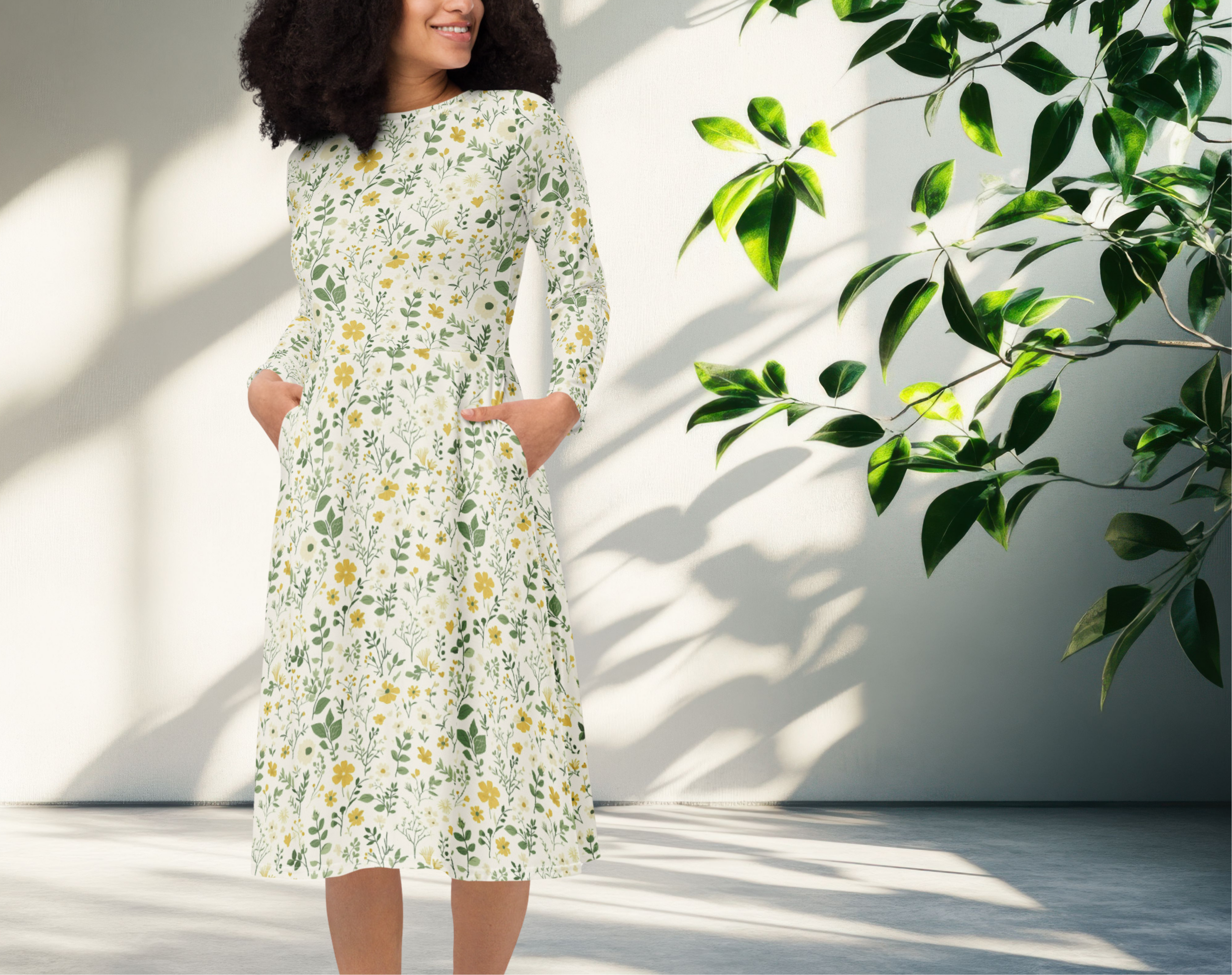 Woman wearing a floral dress standing in a bright room with sunlight casting shadows.