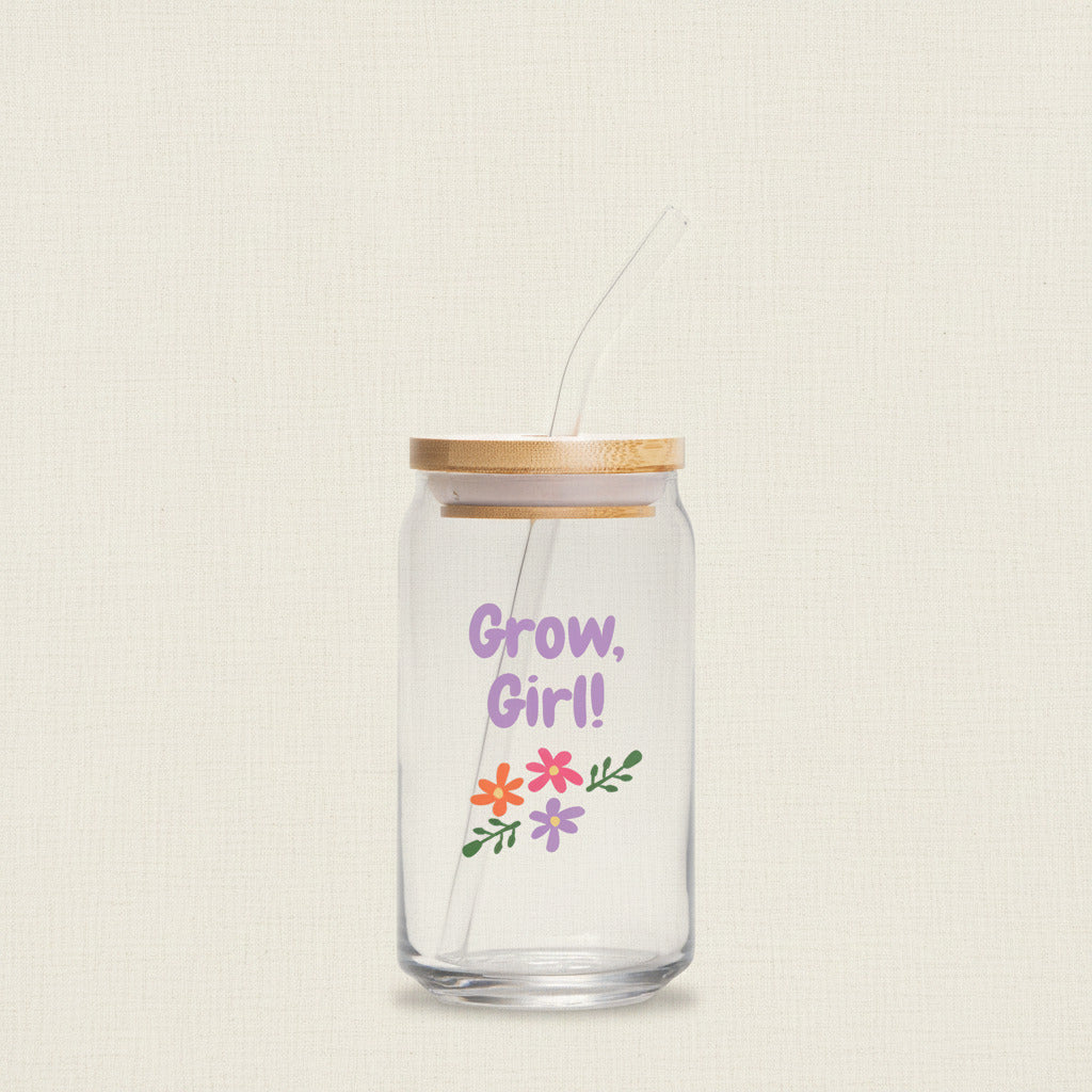 Glass jar with straw and wooden lid, featuring 'Grow, Girl!' text and floral designs on a white background.