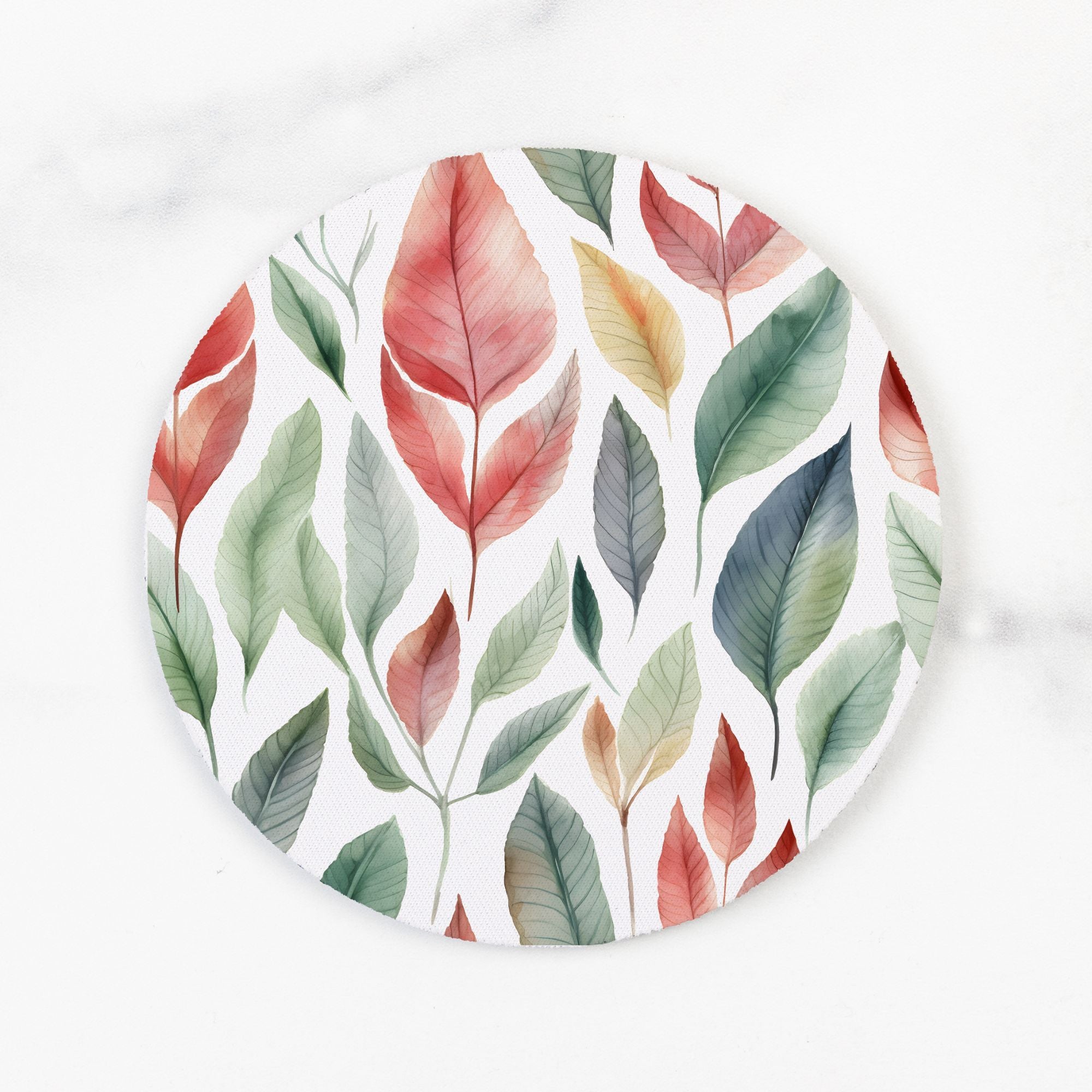 Round white plate with colorful leaf pattern on a white background