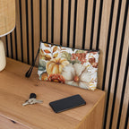 Floral pouch on a wooden surface with keys and a phone