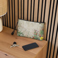 Floral-patterned pouch on a wooden surface with keys and a phone