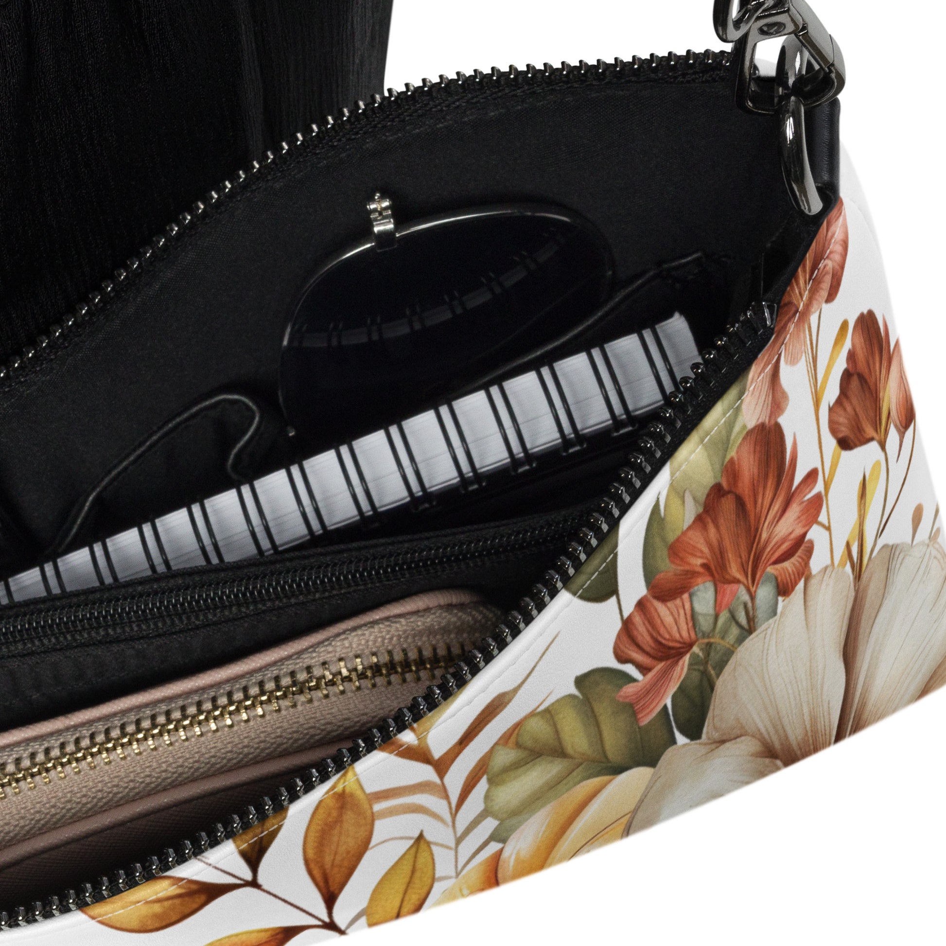 Floral-patterned handbag with a zipper, showing the interior.