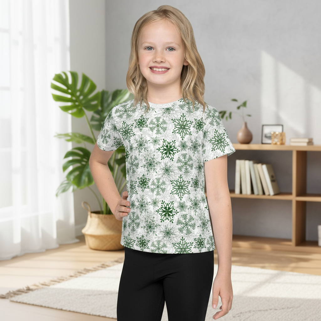 Young girl wearing a white t-shirt with green floral patterns in a room with plants and books.