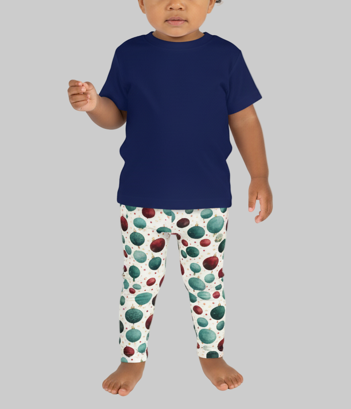 Child wearing a navy blue shirt and colorful polka dot pants on a white background
