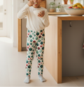 Child wearing colorful polka dot pants in a kitchen setting