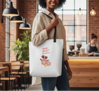 Woman holding a tote bag with floral design and text in a casual setting.