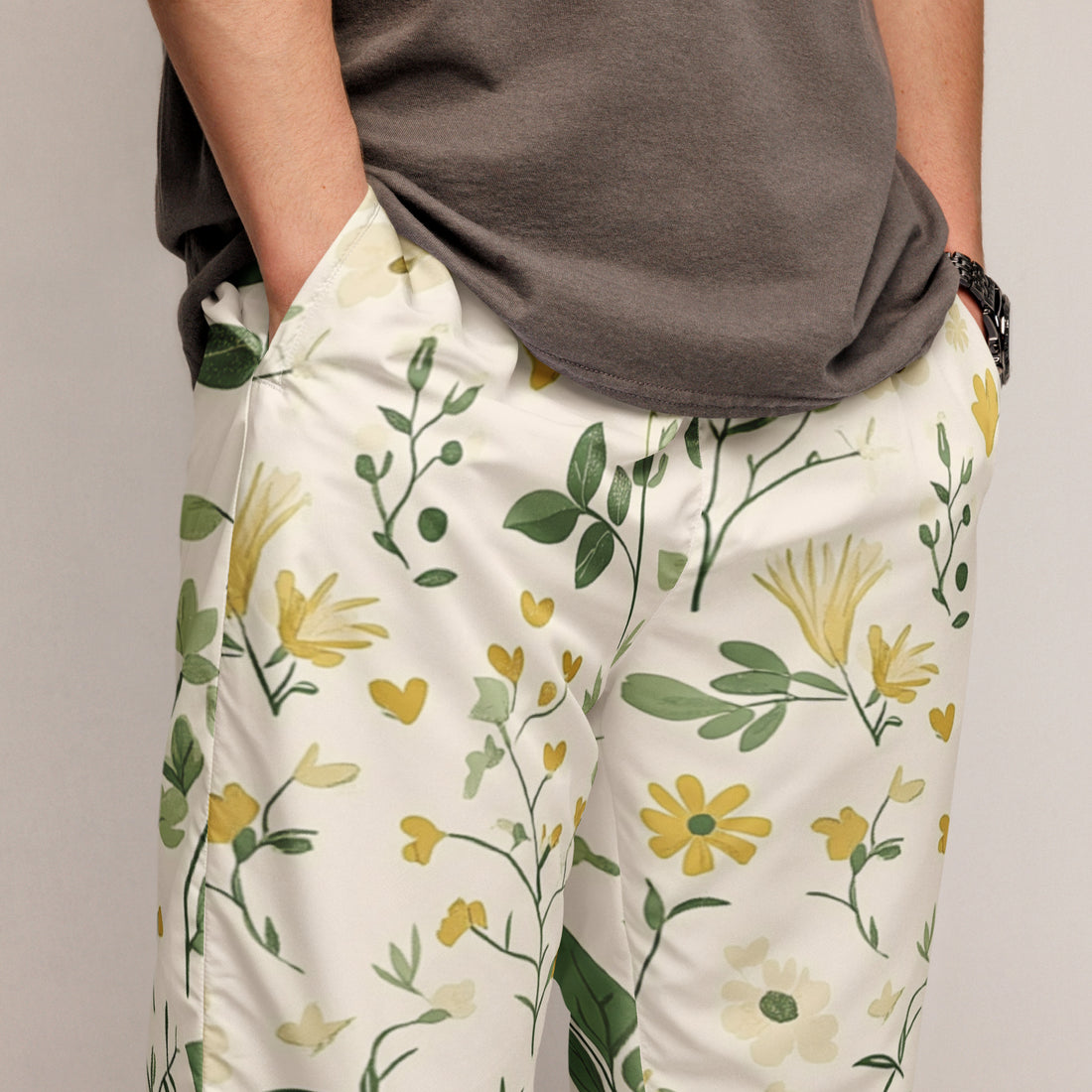 Two people wearing matching floral outfits standing in a room with potted plants.