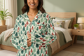 Woman wearing a pajama set with a leaf pattern on a white background