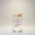 Glass tumbler with straw and wooden lid featuring 'Grow, Girl!' text and floral designs on a white background.