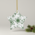 Star-shaped Christmas ornament with green snowflake pattern on a beige background
