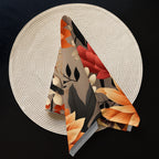 Decorative folded fabric with autumnal pattern on a textured white surface