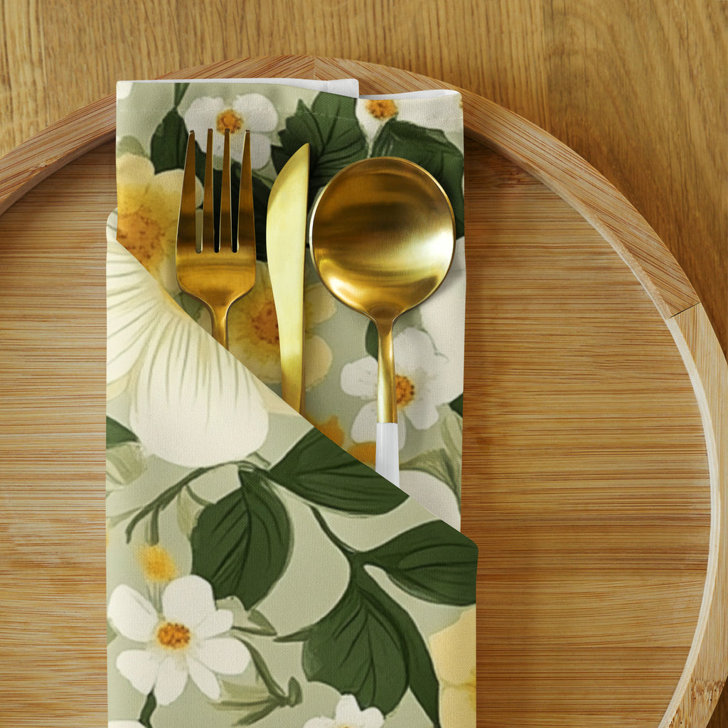 Floral-patterned napkin with gold cutlery on a wooden surface