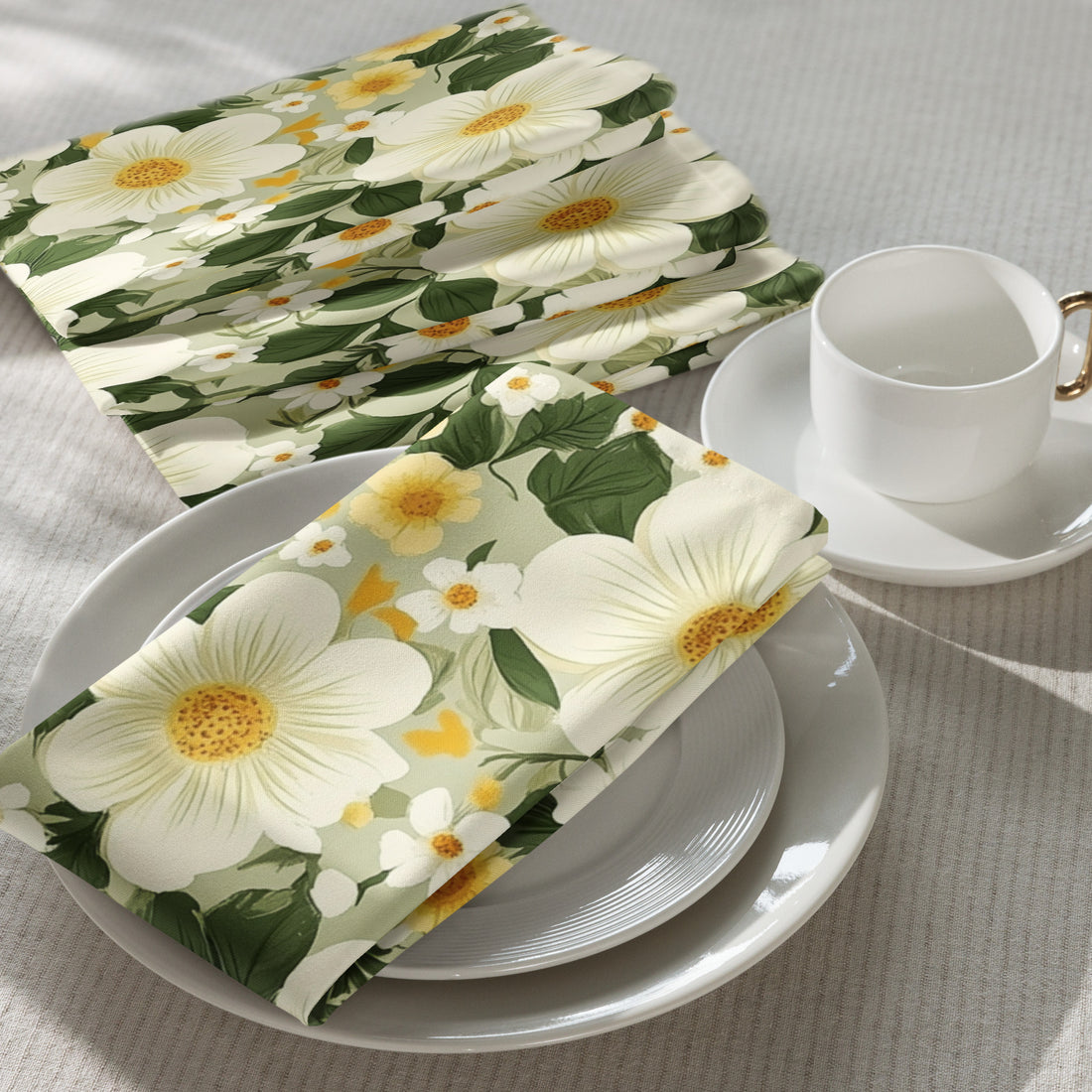 Floral-patterned napkins on a table with a cup and saucer.