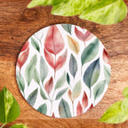 Round coaster with leaf pattern on a wooden surface
