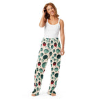 Woman wearing a white tank top and patterned pants on a white background