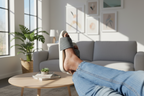 Person relaxing with feet up on a coffee table in a bright living room.